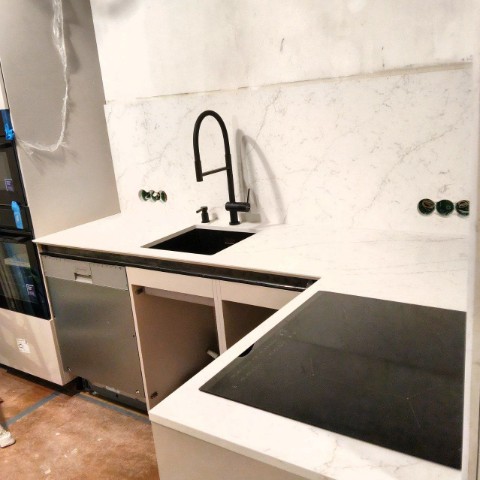 Лаконичная кухня с белой столешницей и кварцевым фартуком